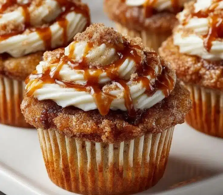 Homemade banana cinnamon roll cupcakes topped with cream cheese frosting