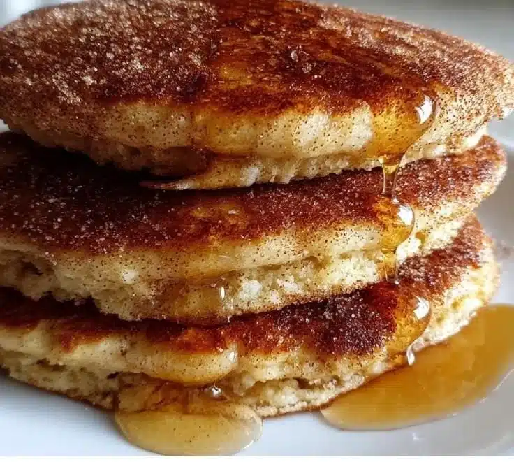 Delicious chai spiced pancakes served with maple syrup and a sprinkle of cinnamon