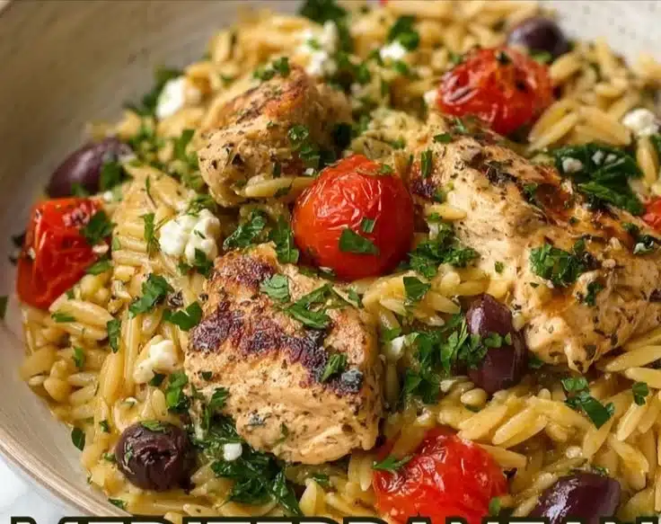 High Protein Mediterranean Chicken Orzo served in a bowl with fresh herbs and vegetables