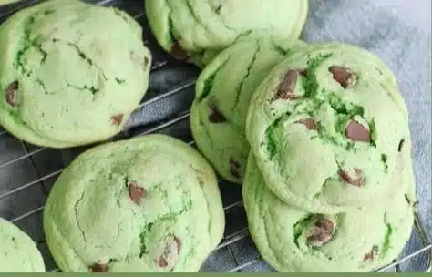 Mint chocolate chip pudding cookies on a plate, fresh out of the oven.