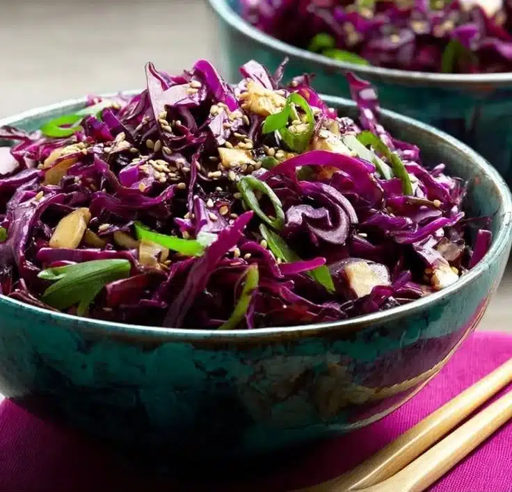 Colorful Asian red cabbage salad with fresh vegetables and dressing