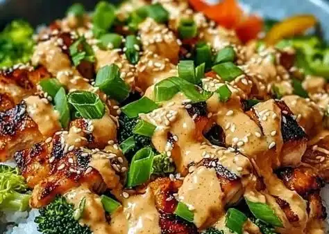 Delicious Bang Bang Chicken Bowl served with fresh vegetables and spicy sauce