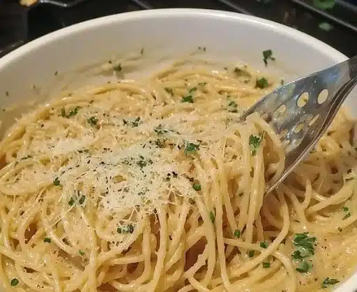 Creamy garlic butter pasta served in a bowl, garnished with parsley