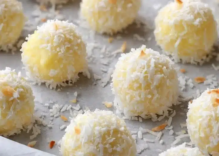 Soft coconut bites with lemon cream lava drizzled with coconut flakes