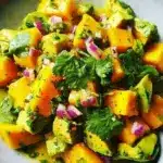 Creamy avocado mango salad with colorful ingredients in a bowl