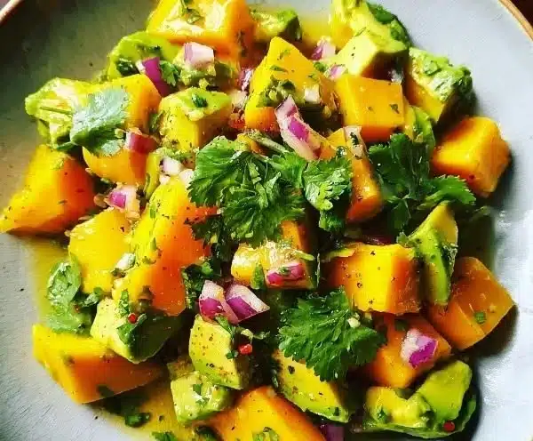 Creamy avocado mango salad with colorful ingredients in a bowl