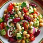 Delicious Greek Bean Salad featuring lemon marinated beans and fresh vegetables.