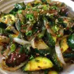 Japanese zucchini and onion stir-fry served in a colorful dish