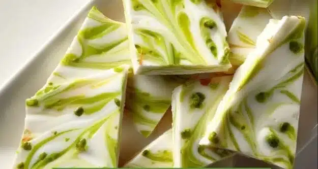 Key Lime Pie Greek Yogurt Bark topped with lime zest and coconut flakes.