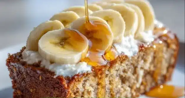 Slices of protein-packed banana bread on a wooden cutting board.