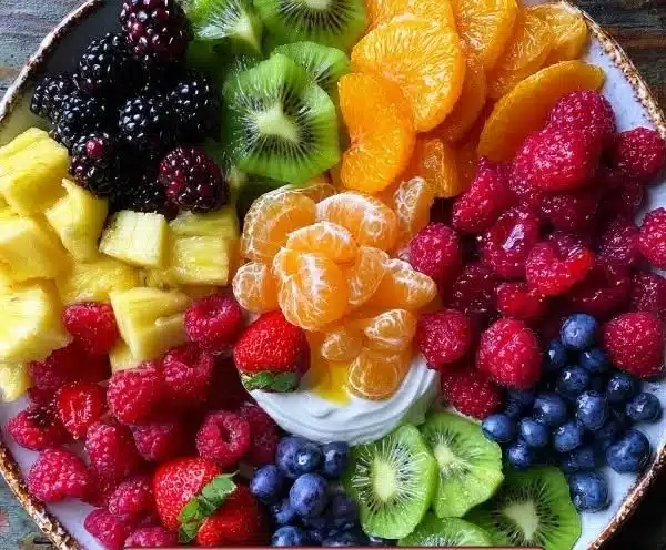 Colorful Rainbow Fruit Board featuring a variety of fresh fruits arranged beautifully.