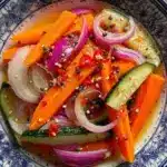 Jar of spicy tangy crunchy pickled vegetables with colorful veggies
