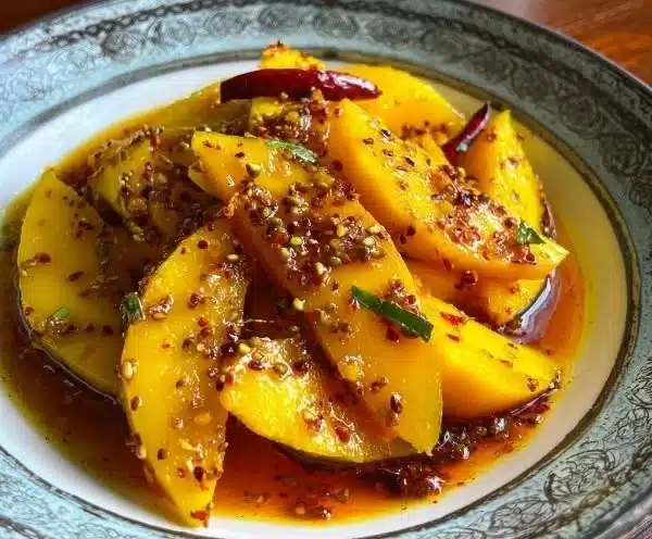 Zesty spicy Indian pickled mango in a glass jar with spices