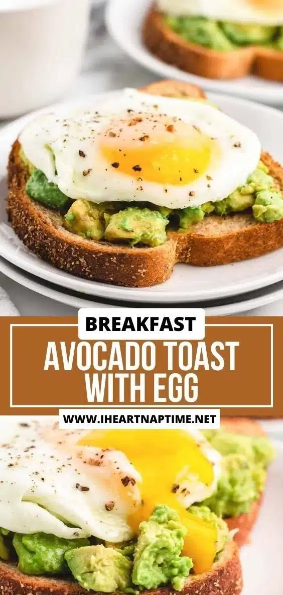 Avocado toast topped with a perfectly cooked egg on a wooden table