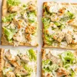 Delicious Chicken Caesar Flatbread topped with fresh ingredients and dressing