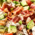 Protein-rich BLT chicken salad topped with crispy bacon and fresh veggies