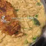 Creamy Chicken Fettuccine Alfredo pasta dish with herbs and parmesan cheese