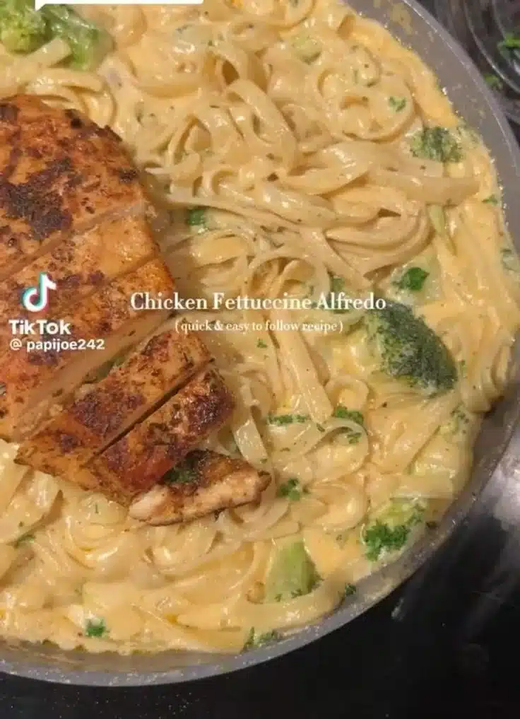 Creamy Chicken Fettuccine Alfredo pasta dish with herbs and parmesan cheese