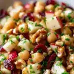 Chickpea, apple, and cranberry salad in a bowl, healthy and colorful meal.
