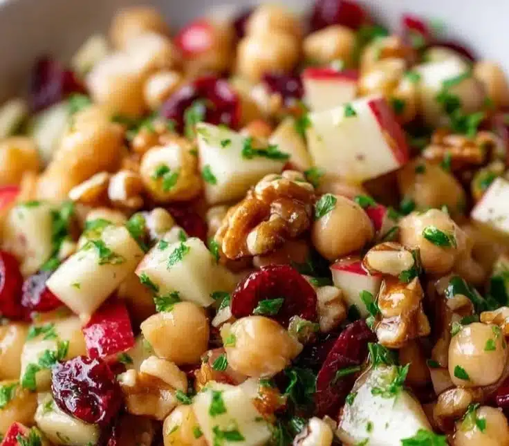 Chickpea, apple, and cranberry salad in a bowl, healthy and colorful meal.