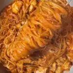Creamy one pot chicken spaghetti served in a bowl with fresh herbs