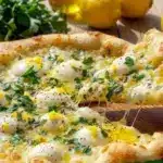 Delicious Lemon Basil Pizza topped with fresh basil and lemon slices
